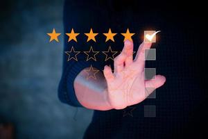 Customer review concept. Businessman hand with rating stars. Customer experience. Customer service evaluation concept. rating very impressed. photo