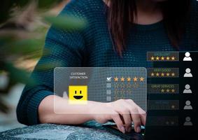 Customer service evaluation and feedback concept. Woman using laptop computer with rating icon. Customer service evaluation concept. rating very impressed. photo