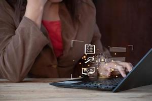 chat AI, Woman using laptop computer with business icon on screen. Internet and technology concept. photo