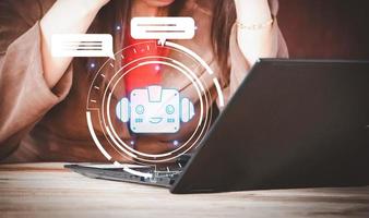 Woman using laptop with robot icon. Artificial intelligence concept. Double exposure, robot application and global connection, conversation AI, business in online network. photo