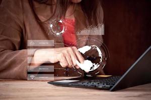 businesswoman working with laptop computer and holding global network connection and graph business diagram, cyber secutity tip. photo
