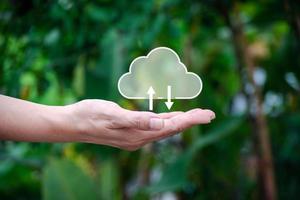 Cloud computing technology concept. Hand holding cloud icon on nature background. And a large database big data Through internet technology. photo