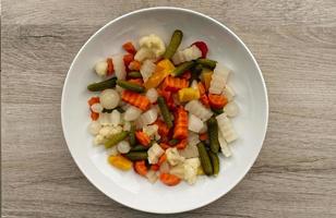 Italian Giardiniera salad, sweet and sour vegetable mix in jar. Top view photo