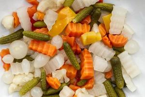 Italian Giardiniera salad, sweet and sour vegetable mix in jar. Close up photo