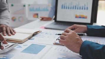 Financial analysts analyze business financial reports on a digital tablet planning investment project during a discussion at a meeting of corporate showing the results of their successful teamwork. video