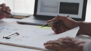 Financial analysts analyze business financial reports on a digital tablet planning investment project during a discussion at a meeting of corporate showing the results of their successful teamwork. video