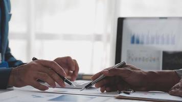 Financial analysts analyze business financial reports on a digital tablet planning investment project during a discussion at a meeting of corporate showing the results of their successful teamwork. video