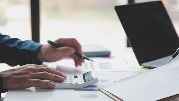 Financial analysts analyze business financial reports on a digital tablet planning investment project during a discussion at a meeting of corporate showing the results of their successful teamwork. video