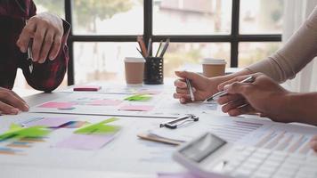 Financial analysts analyze business financial reports on a digital tablet planning investment project during a discussion at a meeting of corporate showing the results of their successful teamwork. video