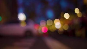 Crowds of people walking in the evening and blurred lights in barcelona, shot with super shallow focus video