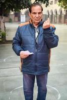 New Delhi, India - December 04 2022 - Unidentified people showing their ink-marked fingers after casting votes in front of polling booth of east Delhi area for MCD local body Elections 2022 photo