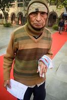 New Delhi, India - December 04 2022 - Unidentified people showing their ink-marked fingers after casting votes in front of polling booth of east Delhi area for MCD local body Elections 2022 photo