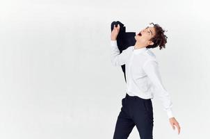 man with curly hair and in a classic suit holds a jacket in his hand fashion style photo