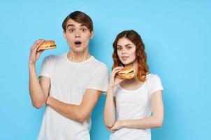 woman and man in white t-shirts fast food diet blue background photo