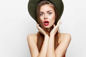 Woman with a hat open mouth luxury bare shoulders on her head evening makeup photo