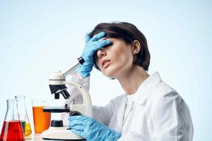 female laboratory assistant chemical solution research work science photo