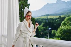 Portrait woman in a robe stands on an open balcony unaltered photo