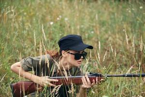Woman soldier take cover on a gun hunt black cap photo