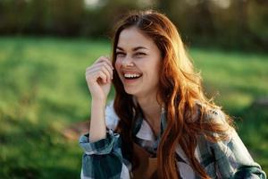 un mujer riendo y sonriente en naturaleza en un verde parque foto