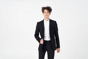 handsome guy with curly hair and in a jacket shirt pants model photo