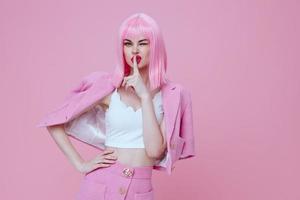 Woman with pink hair on a pink background like a doll photo