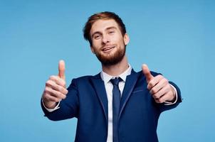 cheerful business man in a suit gesturing with his hands emotions studio photo