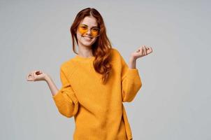 beautiful woman in a yellow sweater fashion glasses isolated background photo