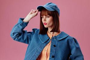 Positive young woman denim cap red lips glamor fashion studio model unaltered photo