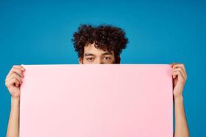 Cheerful guy with pink mockup Poster Copy Space blue background photo