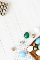 Easter holiday colorful eggs on a board wooden background gifts top view photo