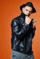 handsome man in leather jacket pumped up torso fashion studio isolated background photo