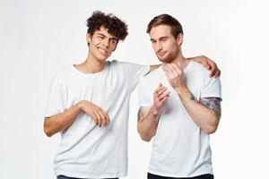 two guys in white t-shirts next to friendship communication emotions photo