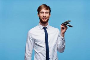 man with wad of money finance official blue background photo