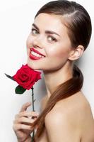 Lady with rose bright Smile flower near the face makeup photo