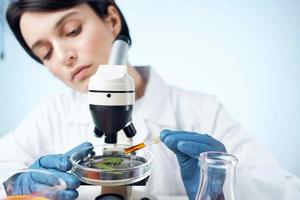 female laboratory assistant arranging spectroscope research science biotechnology photo