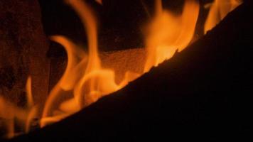 A close up of flames in log fire burning in a fireplace video