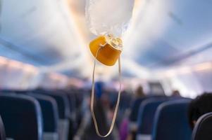 oxygen mask drop from the ceiling compartment on airplane photo