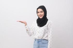 Portrait of beautiful muslim woman with hijab over white background studio. photo