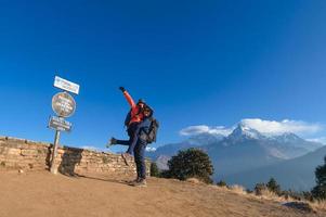 A young traveller trekking in Poon Hill view point in Ghorepani, Nepal photo