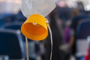 oxygen mask drop from the ceiling compartment on airplane photo