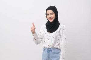 Portrait of beautiful muslim woman with hijab over white background studio. photo