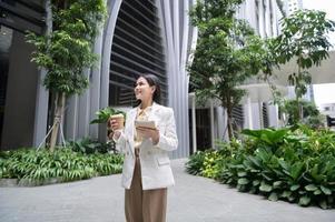 A young businesswoman is working in modern city downtown of Singapore photo