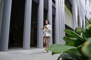 A young businesswoman is working in modern city downtown of Singapore photo