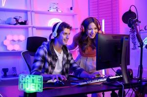 Young professionals  play video games together live streaming their matches  and speak with their fans at  homes. photo