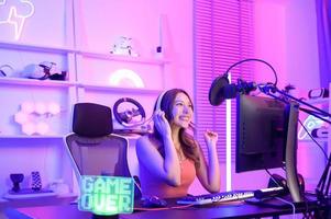 Young Asian Pretty woman Pro Gamer have live streaming , singing  and chatting  with her fans  at home photo