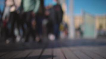 Crowds of people walking on a bridge in barcelona shot with super shallow focus video