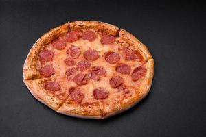 Delicious fresh pepperoni pizza with sesame seeds on the sides photo