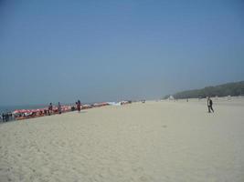 Photo of a sunny day view of a beautiful winter beach and sea on a sunny day in Innany beach of Cox's Bazar, Bangladesh. Travel and Vacation.