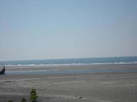 Photo of natural landscape view of a beautiful winter beach and sea on a sunny day in Cox's Bazar, Bangladesh. Travel and Vacation.