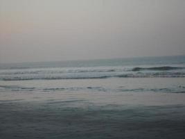 Photo of natural landscape view of beautiful winter beach and sea on a sunny day in Cox's Bazar, Bangladesh. Travel and Vacation.